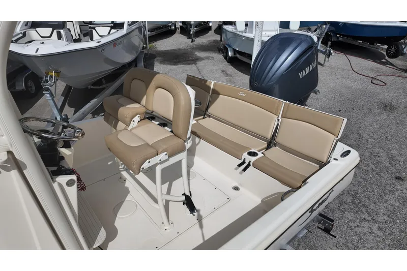 Slide: The Image of 2021 Scout 251 XSS boat interior with beige seating and Yamaha engine. - 11