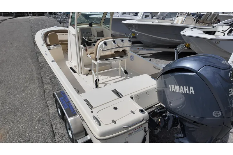 Slide: The Image of 2021 Scout 251 XSS boat with Yamaha engine, parked on a trailer. - 13