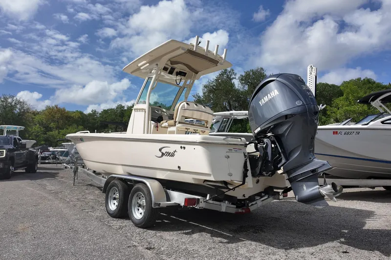 Slide: The Image of 2021 Scout 251 XSS boat with Yamaha engine on trailer, parked outdoors. - 2