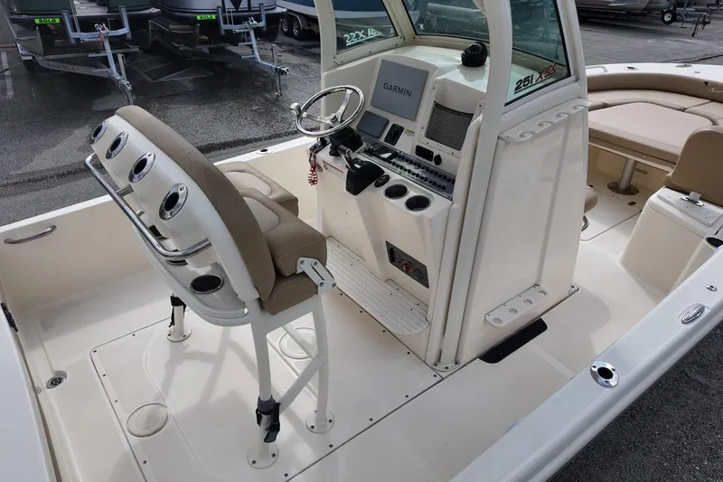Slide: The Image of 2021 Scout 251 XSS boat interior with helm, seating, and Garmin navigation system. - 4