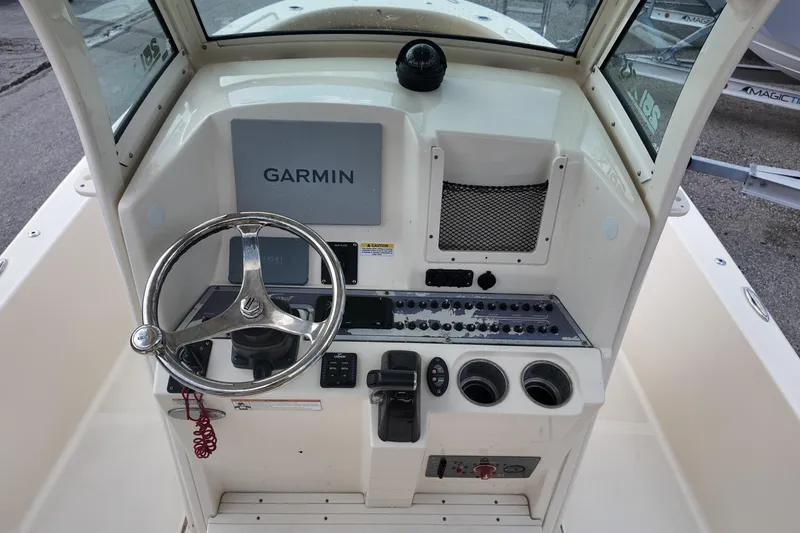 Slide: The Image of 2021 Scout 251 XSS boat dashboard with Garmin navigation system and steering wheel. - 5