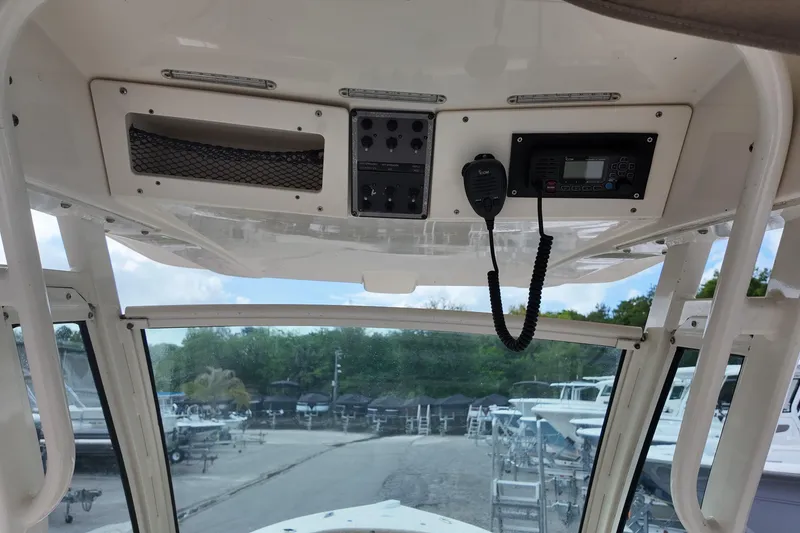 Slide: The Image of Interior view of 2021 Scout 251 XSS boat's control panel with radio and switches. - 6