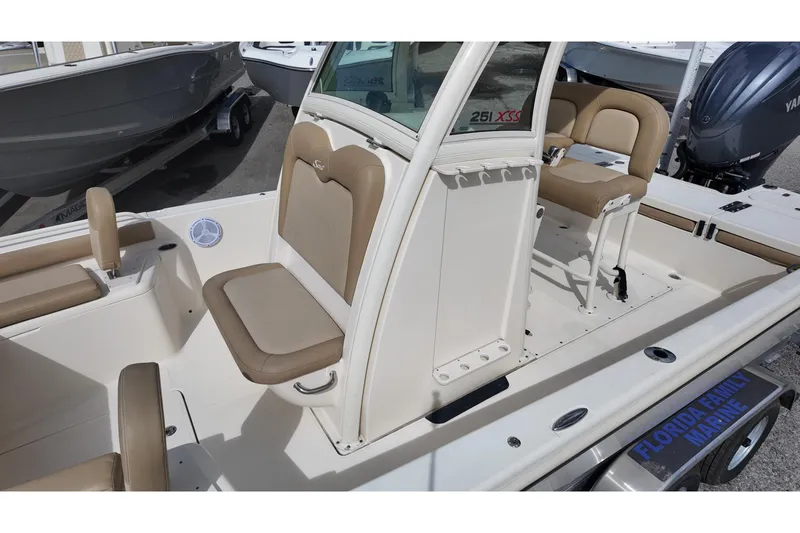 Slide: The Image of 2021 Scout 251 XSS boat interior with beige seating and console details. - 9