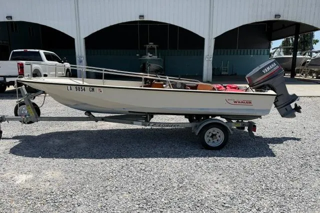 The Image of 1984 Boston Whaler 150 Sport boat on trailer with Yamaha outboard motor. - 0