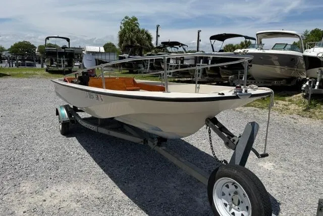 Slide: The Image of 1984 Boston Whaler 150 Sport boat on trailer in outdoor setting. - 7