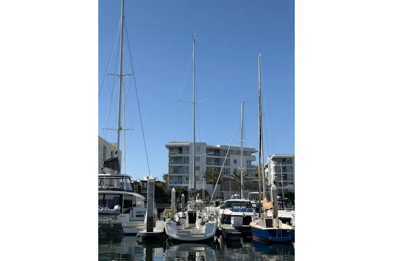 Slide: The Image of 2024 Jeanneau Sun Odyssey 349 sailboat docked in a marina under clear blue skies. - 34