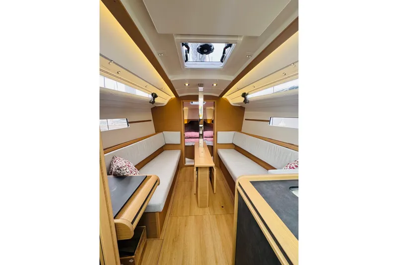 Slide: The Image of Interior of 2024 Jeanneau Sun Odyssey 349 sailboat, featuring modern seating and wood finishes. - 42