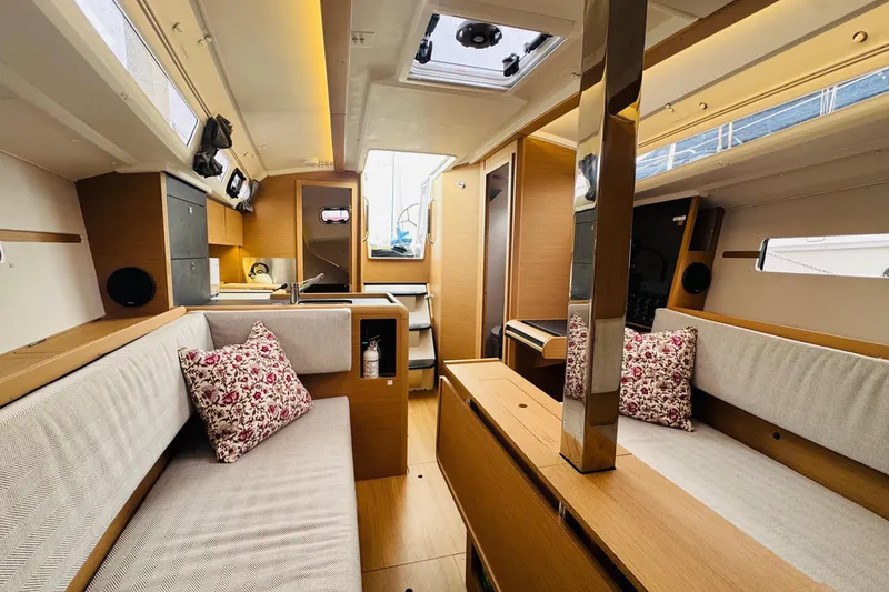 Slide: The Image of 2024 Jeanneau Sun Odyssey 349 interior with modern design and cozy seating area. - 53