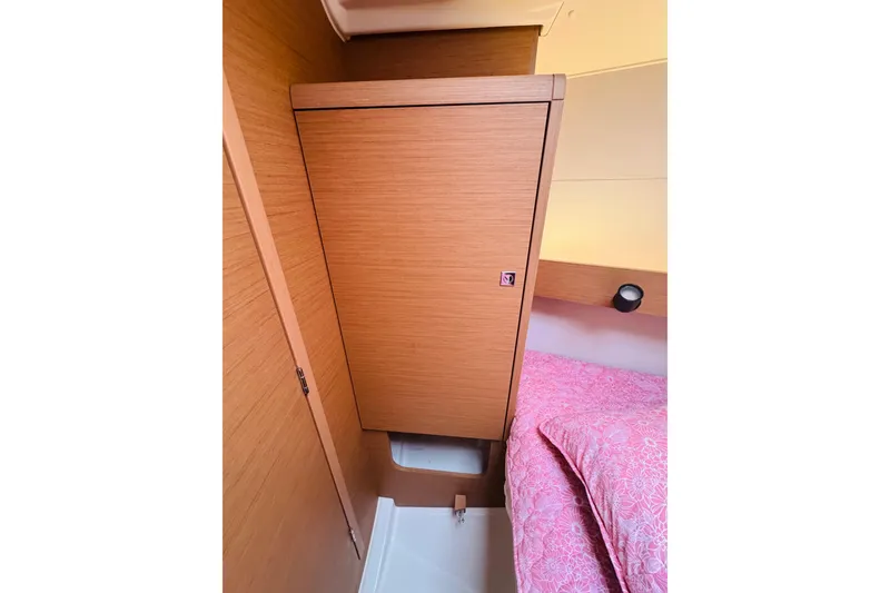 Slide: The Image of Interior cabin of 2024 Jeanneau Sun Odyssey 349 with wooden cabinetry and pink bedding. - 65