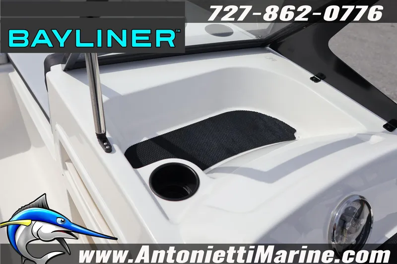 Slide: The Image of 2026 Bayliner Element M17 boat dashboard with cup holder and storage area. - 19
