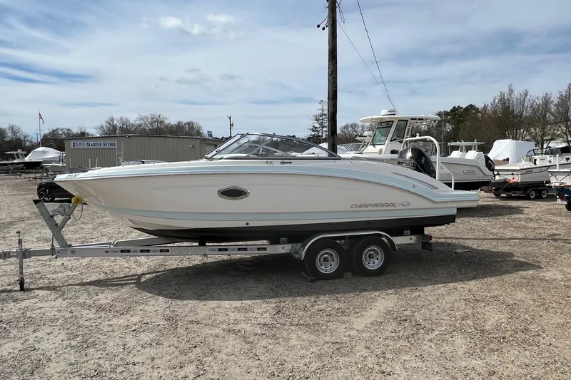 The Image of 2021 Chaparral 230 Suncoast boat on trailer at a marina, ready for transport. - 0