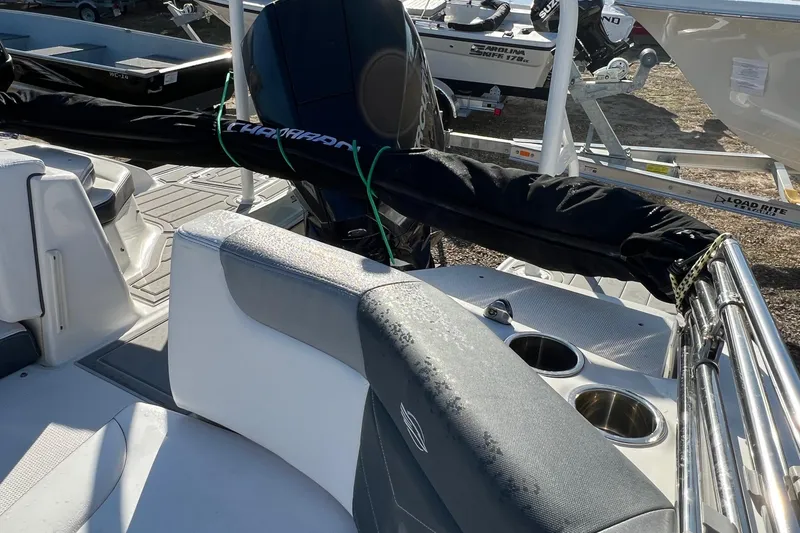 Slide: The Image of 2021 Chaparral 230 Suncoast boat interior with seating and cup holders. - 12