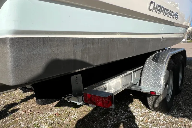 Slide: The Image of 2021 Chaparral 230 Suncoast boat on trailer, side view with visible logo. - 15