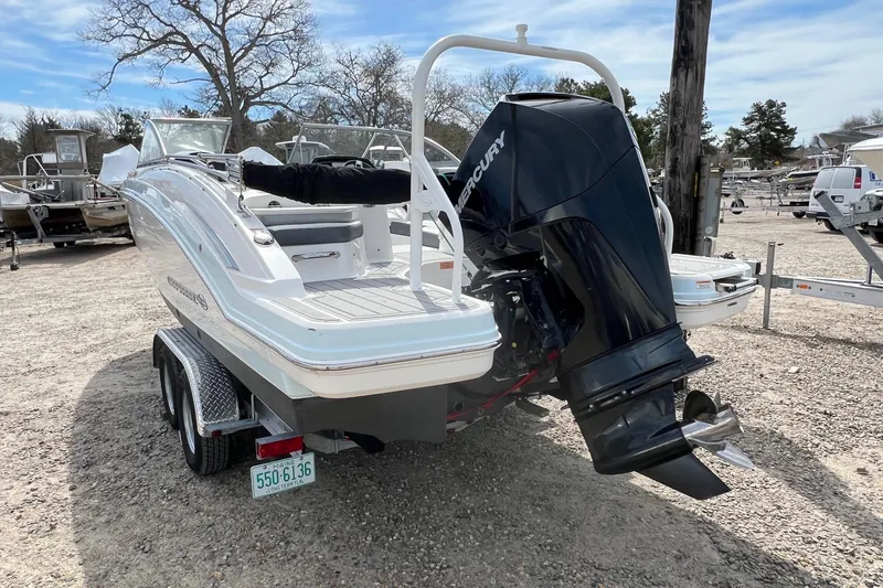 Slide: The Image of 2021 Chaparral 230 Suncoast boat with Mercury outboard engine on trailer. - 2
