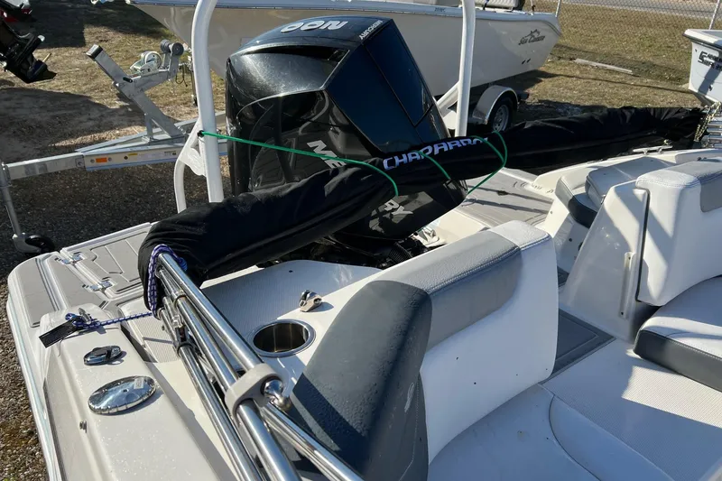 Slide: The Image of 2021 Chaparral 230 Suncoast boat interior with engine and seating area. - 24