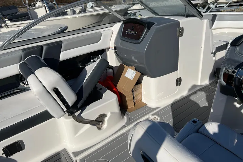 Slide: The Image of 2021 Chaparral 230 Suncoast boat interior with seating and storage area. - 28
