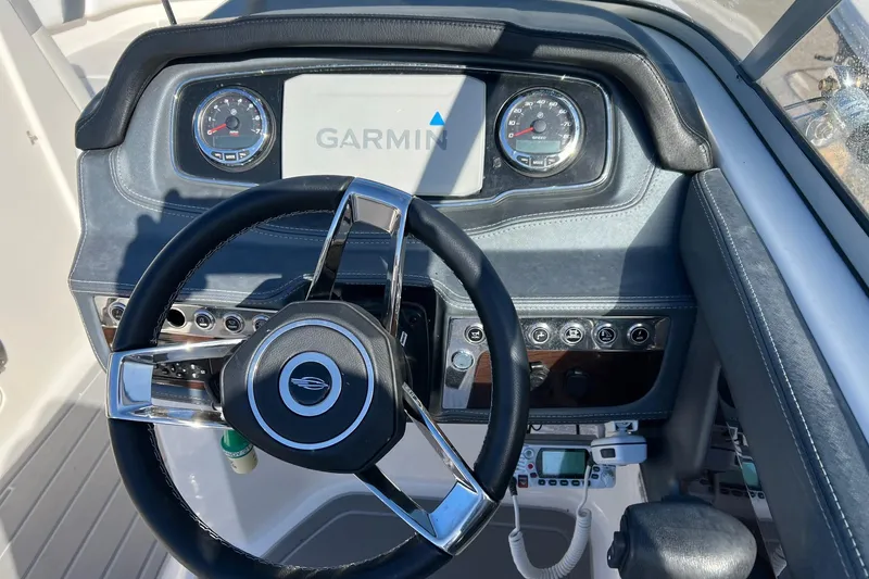Slide: The Image of Steering console of 2021 Chaparral 230 Suncoast boat with Garmin navigation system. - 30
