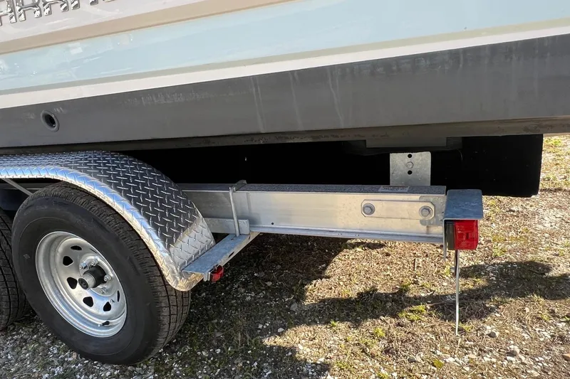 Slide: The Image of Trailer with Chaparral 230 Suncoast boat, 2021 model, on gravel surface. - 39
