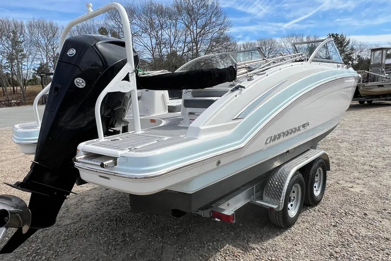 Slide: The Image of 2021 Chaparral 230 Suncoast boat on trailer, featuring sleek design and powerful outboard motor. - 4