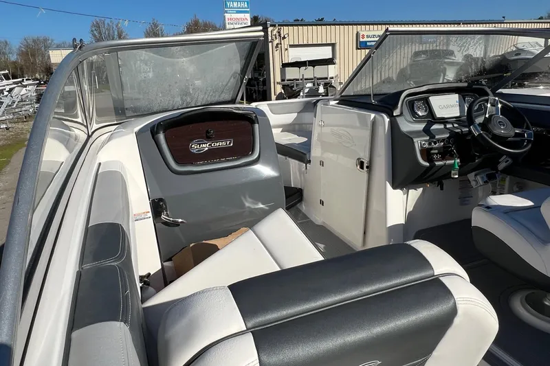 Slide: The Image of 2021 Chaparral 230 Suncoast boat interior with steering wheel and seating. - 41