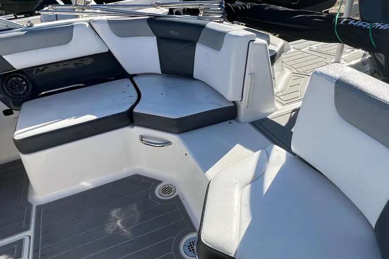 Slide: The Image of 2021 Chaparral 230 Suncoast boat interior with cushioned seating and modern design. - 43