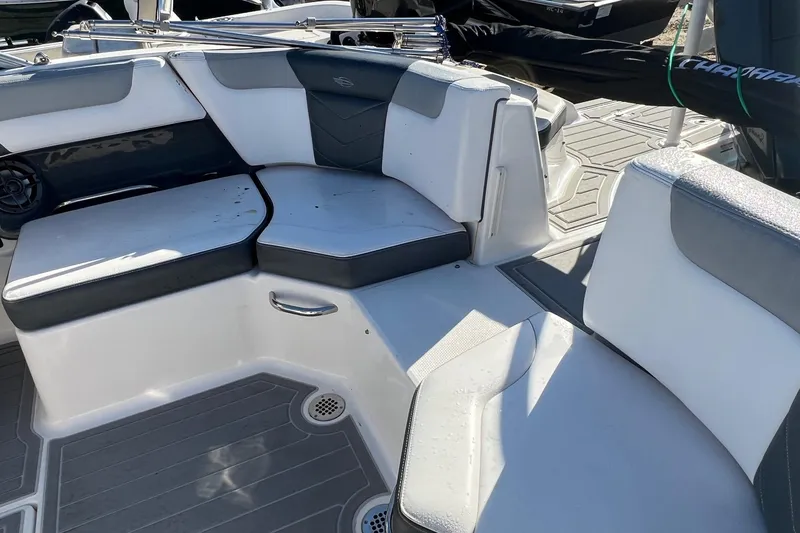 Slide: The Image of 2021 Chaparral 230 Suncoast boat interior with cushioned seating and modern design. - 44