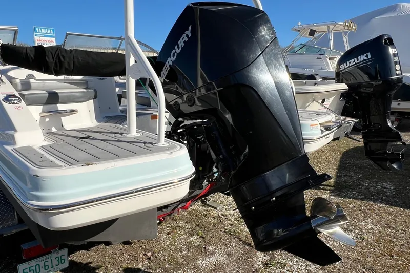 Slide: The Image of 2021 Chaparral 230 Suncoast boat with Mercury outboard motor, docked outdoors. - 6