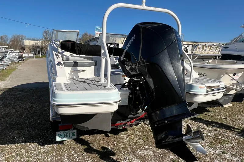 Slide: The Image of 2021 Chaparral 230 Suncoast boat with Mercury outboard motor, parked outdoors. - 8