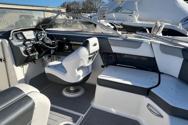 Slide: The Image of Interior of a 2021 Chaparral 230 Suncoast boat with modern seating and dashboard. - 9