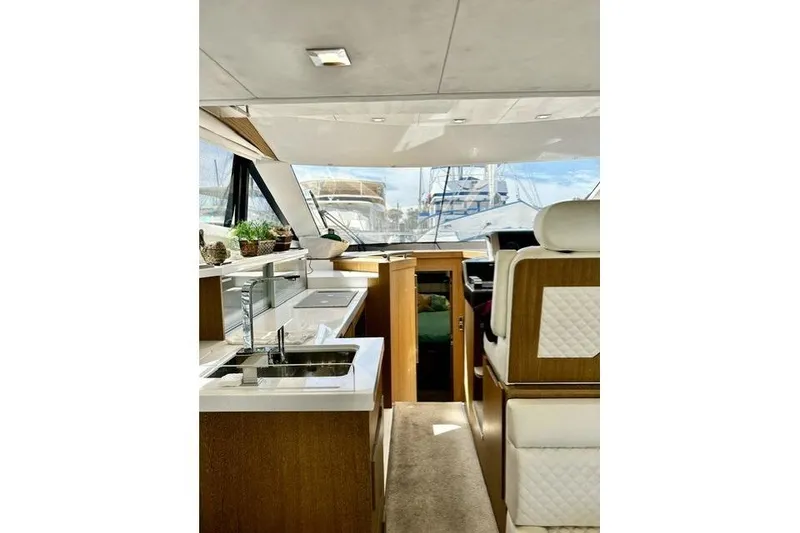 Slide: The Image of Interior of 2018 Galeon 420 Fly yacht with modern kitchen and seating area. - 4