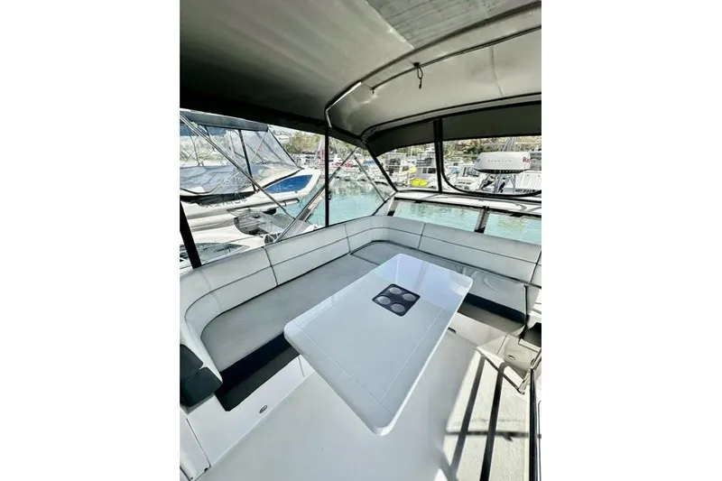 Slide: The Image of Interior of 2018 Galeon 420 Fly yacht with seating and table, docked at marina. - 5
