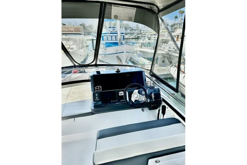 Slide: The Image of Interior view of 2018 Galeon 420 Fly yacht cockpit with steering wheel and navigation controls. - 6