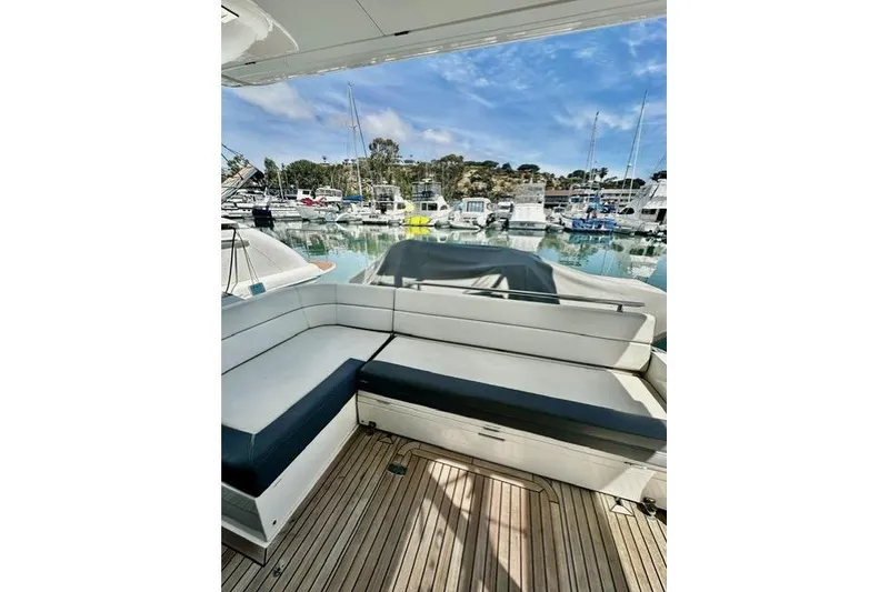 Slide: The Image of 2018 Galeon 420 Fly yacht with sleek seating, docked in a scenic marina. - 8
