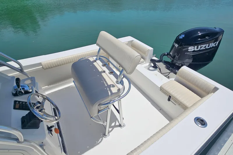 Slide: The Image of 2005 Mako 212 Center Console boat with Suzuki outboard motor on calm water. - 12