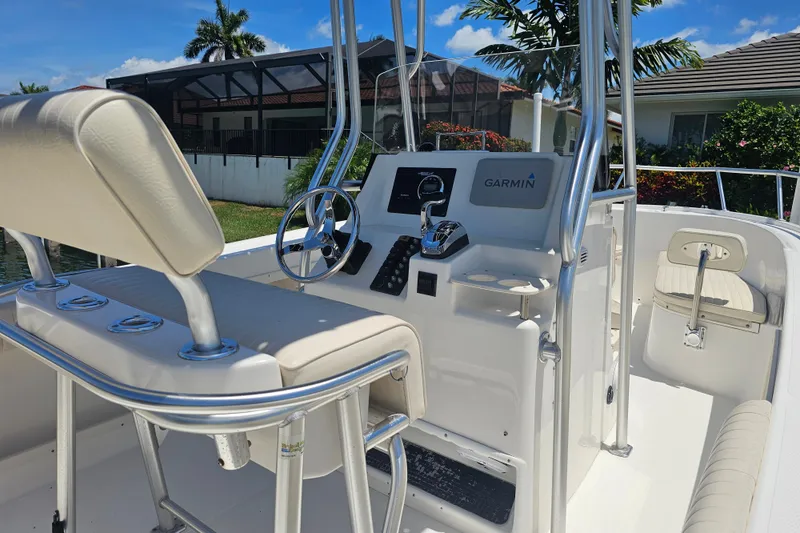 Slide: The Image of 2005 Mako 212 Center Console boat with Garmin navigation system, sleek design, and comfortable seating. - 14