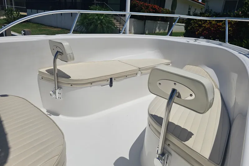 Slide: The Image of 2005 Mako 212 Center Console boat interior with cushioned seating and railings. - 16