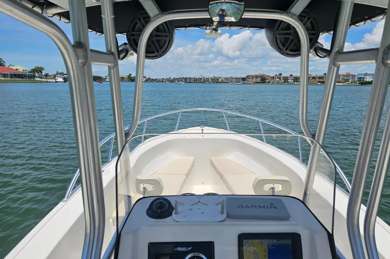 Slide: The Image of 2005 Mako 212 Center Console boat on calm water with clear sky. - 18