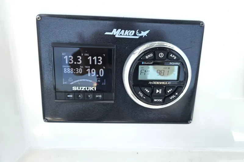 Slide: The Image of Control panel of a 2005 Mako 212 Center Console boat with Suzuki and Rockville displays. - 19