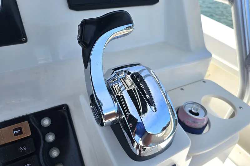 Slide: The Image of Chrome throttle control on a 2005 Mako 212 Center Console boat dashboard. - 21