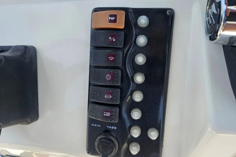 Slide: The Image of Control panel of a 2005 Mako 212 Center Console boat with labeled switches. - 22