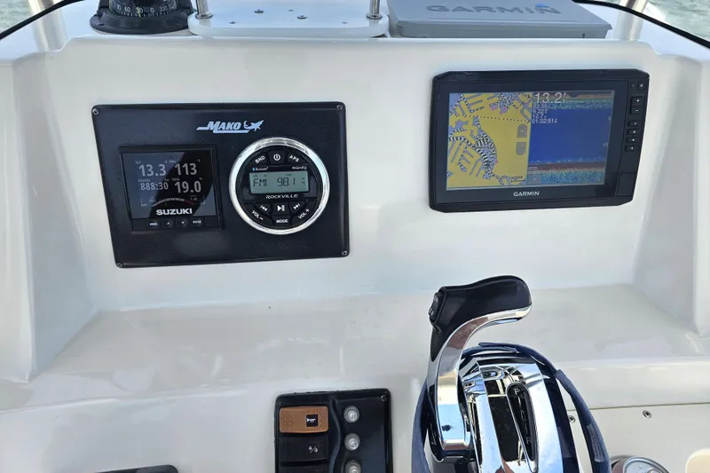 Slide: The Image of Center console of a 2005 Mako 212 boat with Suzuki and Garmin displays. - 23