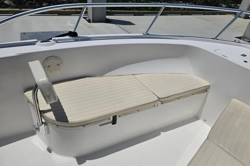 Slide: The Image of 2005 Mako 212 Center Console boat interior with cushioned seating and railings. - 28