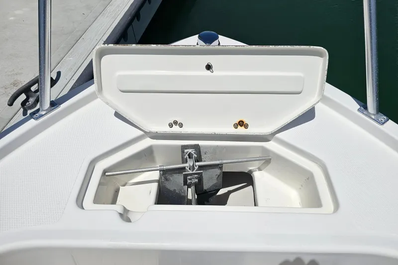 Slide: The Image of Open anchor compartment on a 2005 Mako 212 Center Console boat. - 29