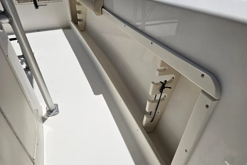 Slide: The Image of Interior view of a 2005 Mako 212 Center Console boat, showcasing storage compartment. - 32