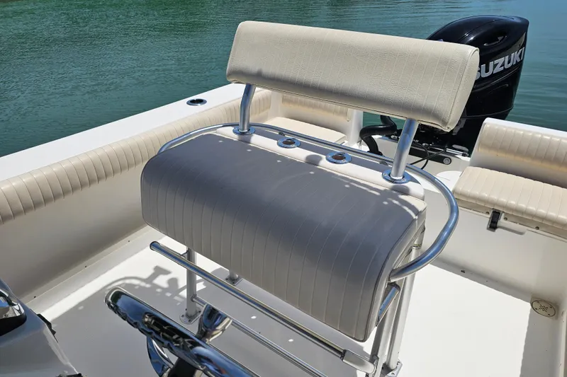 Slide: The Image of 2005 Mako 212 Center Console boat interior with seating and Suzuki outboard motor. - 34