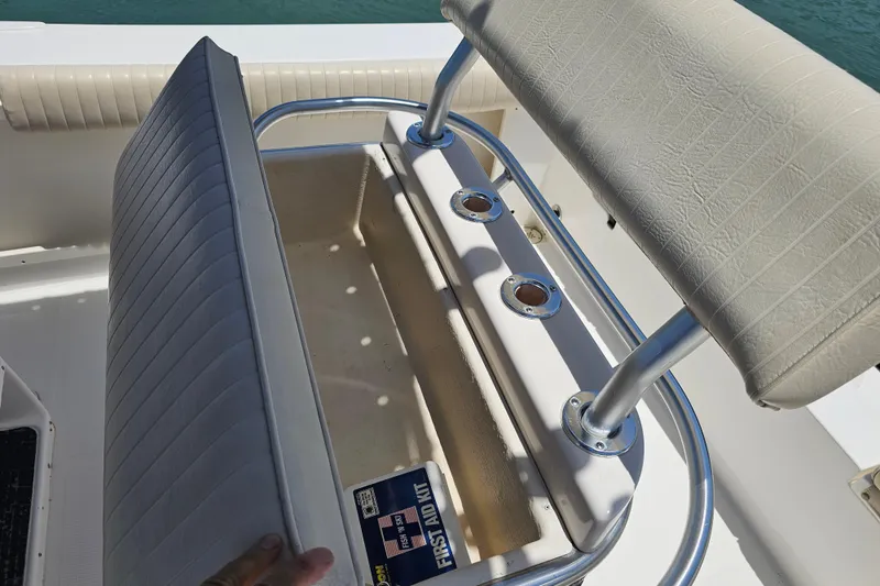 Slide: The Image of 2005 Mako 212 Center Console boat seat with storage compartment and first aid kit. - 35