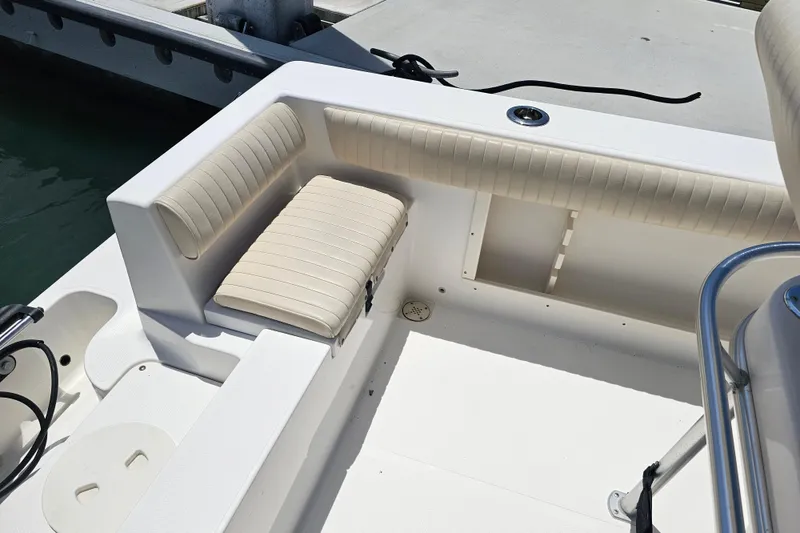 Slide: The Image of 2005 Mako 212 Center Console boat interior with cushioned seating and storage. - 39