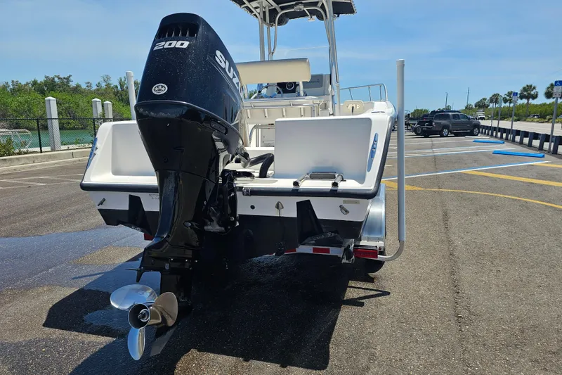 Slide: The Image of 2005 Mako 212 Center Console boat with Suzuki 200 outboard motor in parking lot. - 5