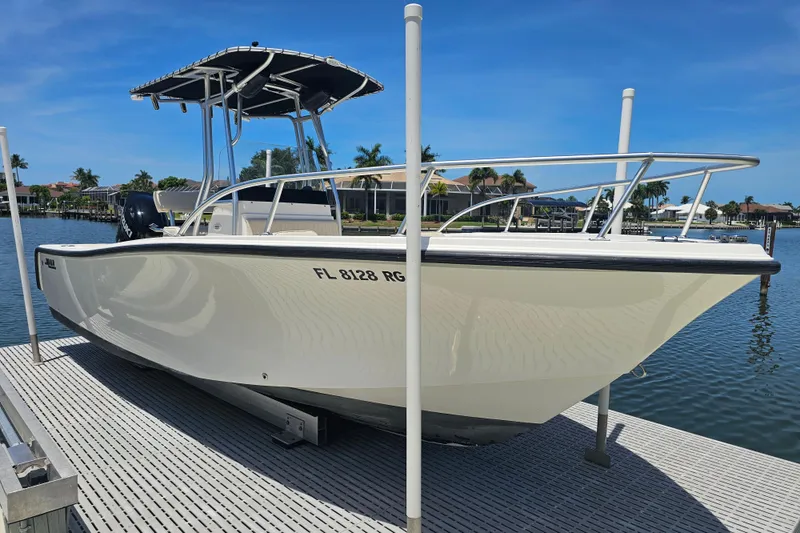 Slide: The Image of 2005 Mako 212 Center Console boat docked on a sunny day. - 7