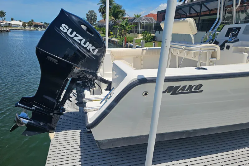 Slide: The Image of 2005 Mako 212 Center Console boat with Suzuki outboard motor docked by waterfront. - 9